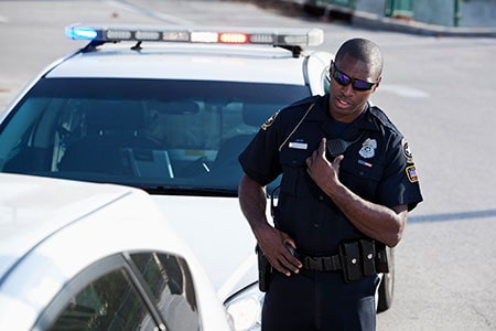 African American Police Officer Pulling Over a Car